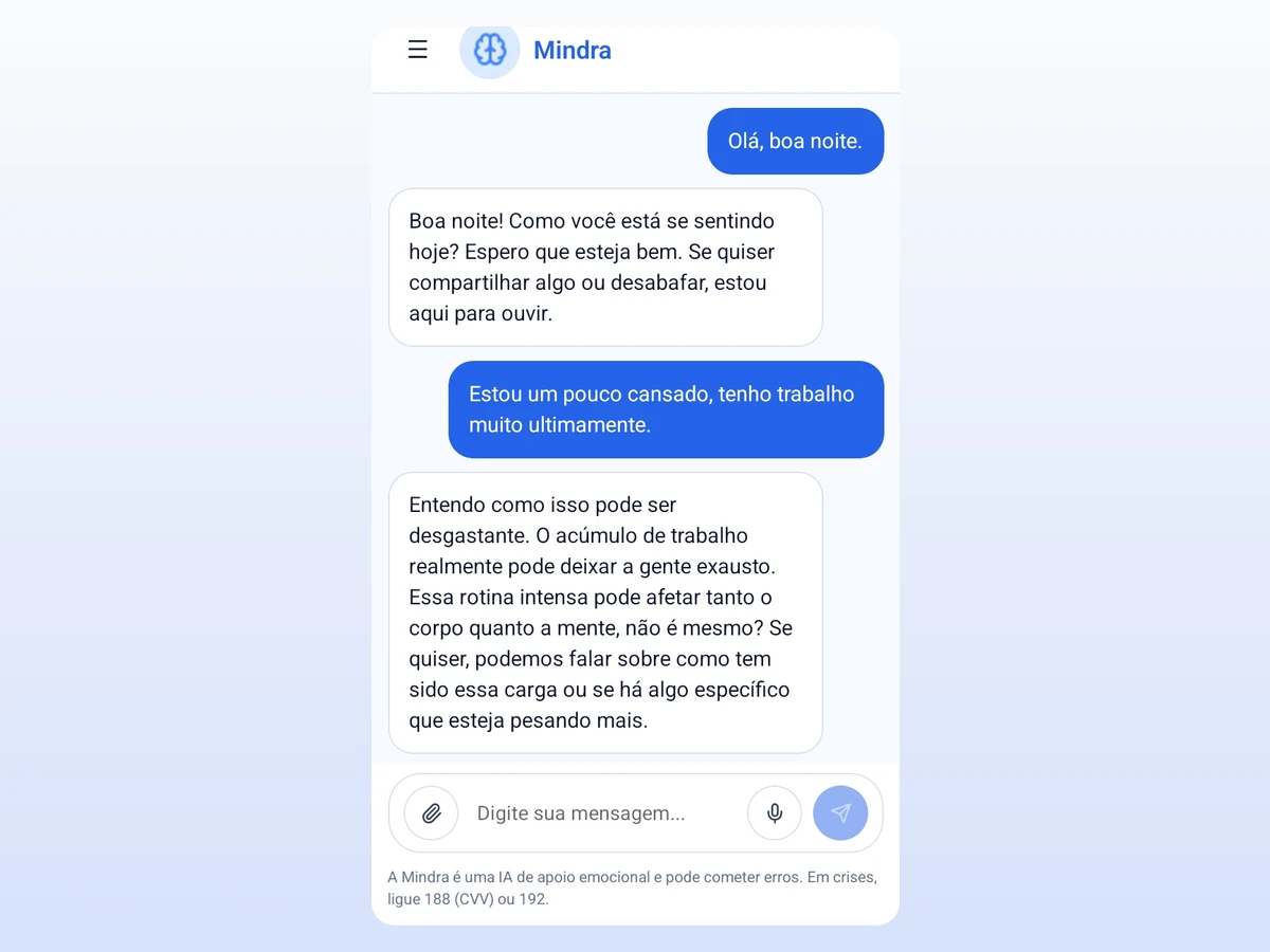 Conversa na Mindra por voz ou texto, com o aviso de que é uma IA de apoio emocional e os números de emergência